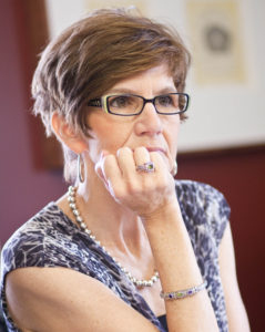 This is a photo of Patricia Baker listening during a meeting.