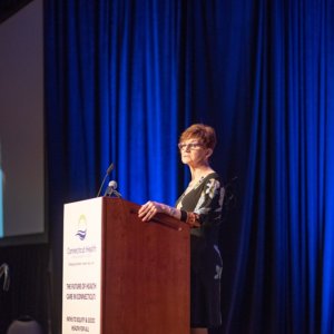 This is a picture of Patricia Baker standing at a podium during the Connecticut Health Foundation's 2018 thought event.