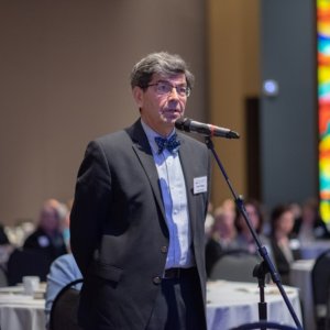 This is a picture of Dr. Victor Villagra standing at a microphone to ask a question during the Connecticut Health Foundation's 2018 thought event.