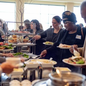 This is a picture of people getting food from a buffet line