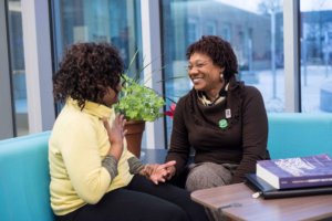 This is a photo of Loretta D. Lloyd-Ebron chatting with a woman.