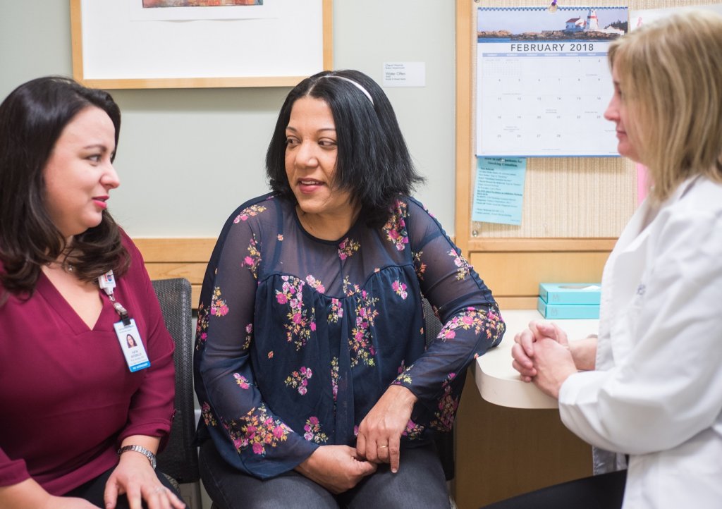 This is a photo of a patient, community health worker and doctor at Project Access New Haven.